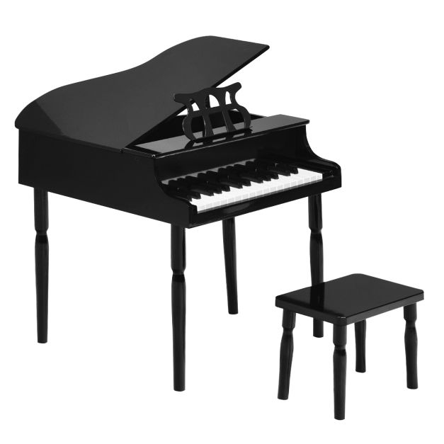 Clavier d'un piano noir et partition de musique sur le pupitre Stock Photo